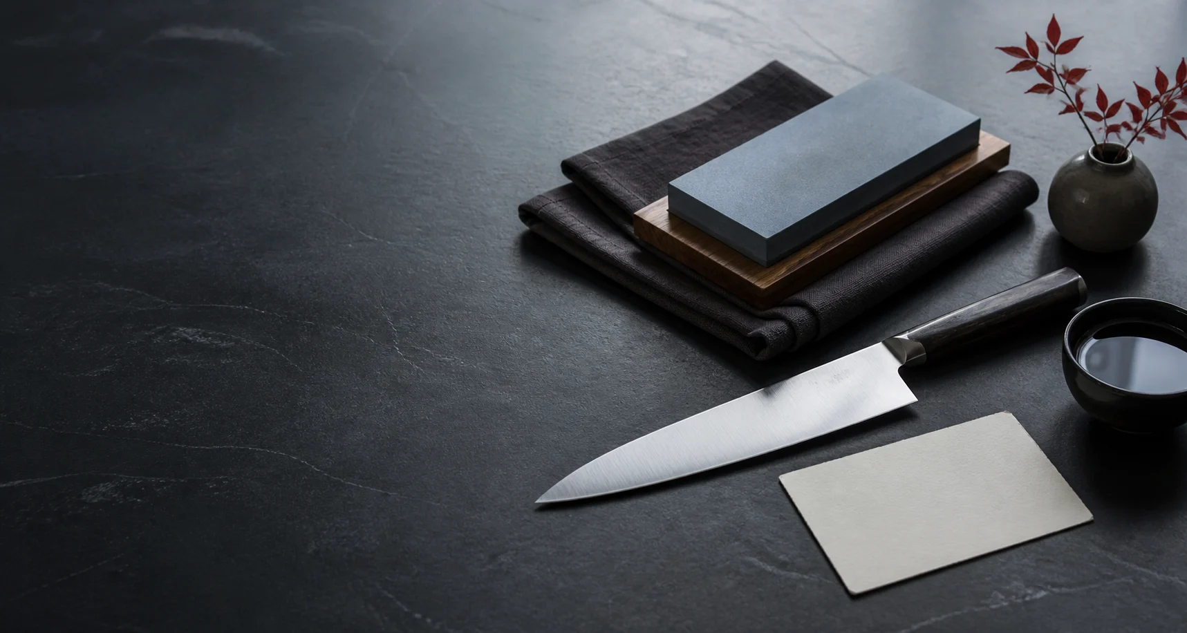 Knife care tools arranged on a dark service counter